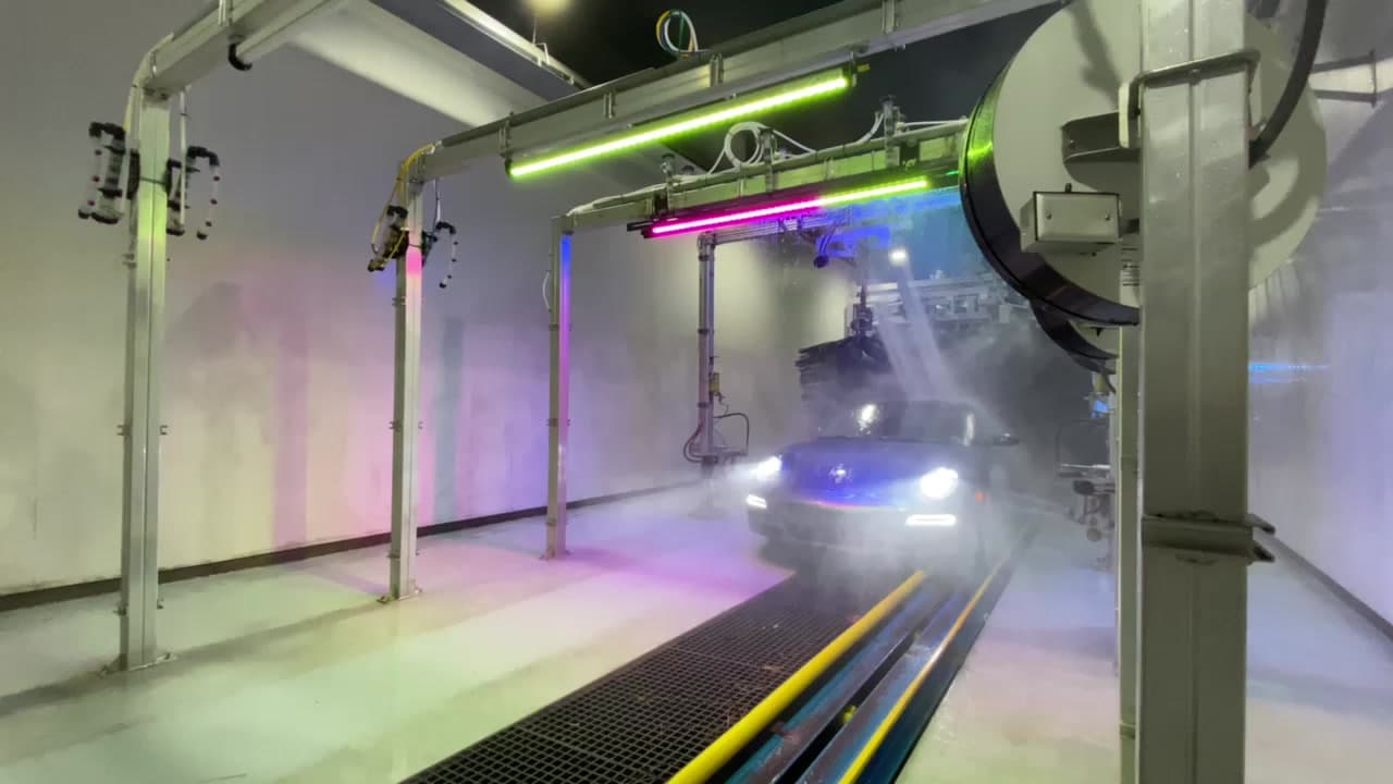 Inside a Century Express wash tunnel, lit by coloured LED tubes