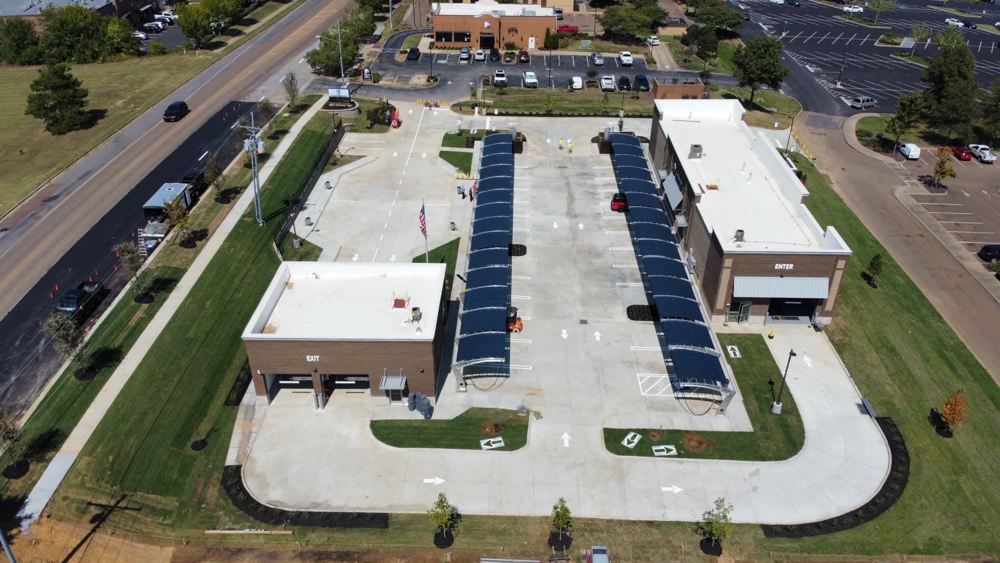 Aerial view of a Century Express Carwash location, showing the covered wash tunnel bays and parking lot.